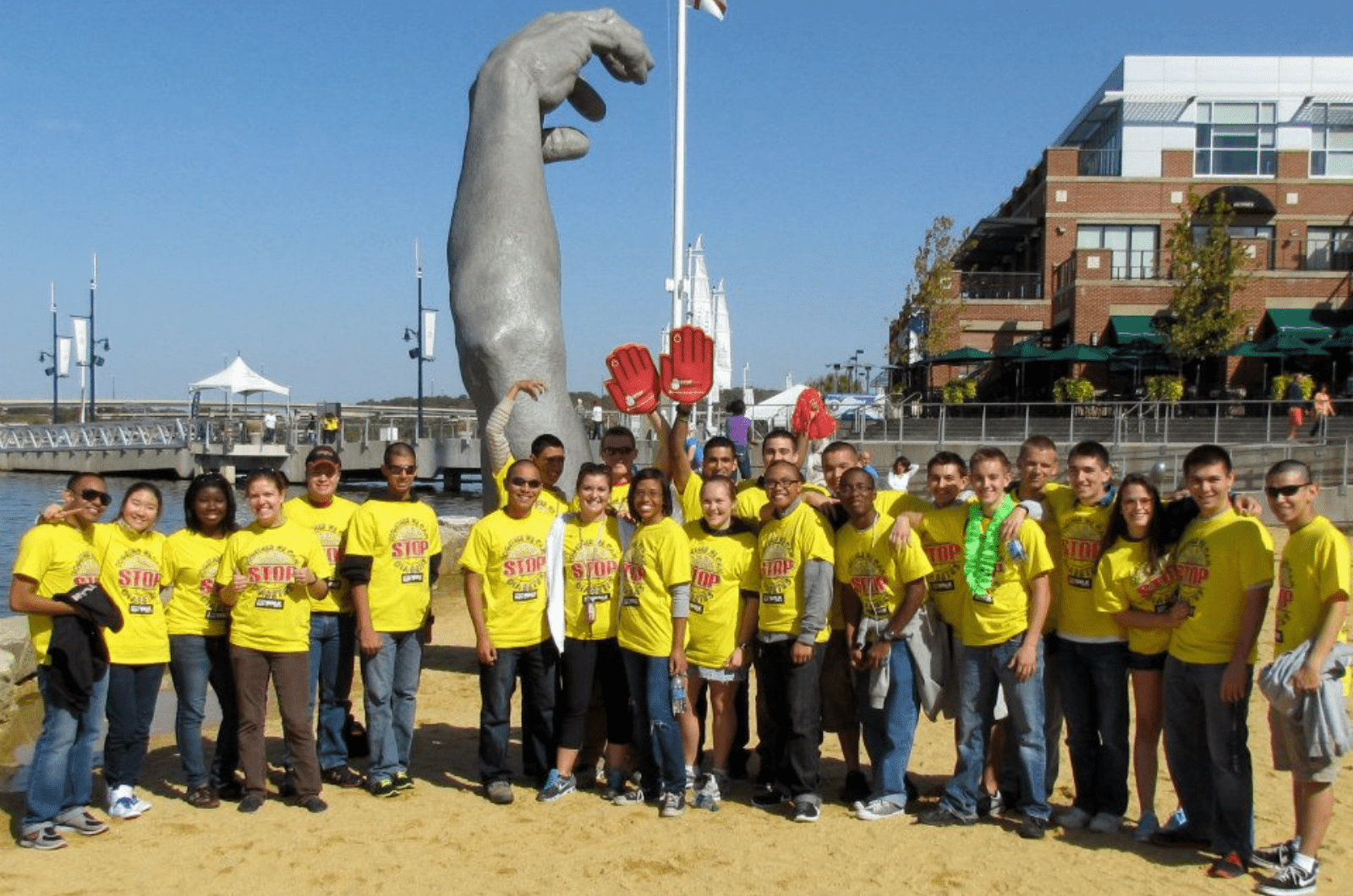 group photo of arnold society members in matching yellow shirts