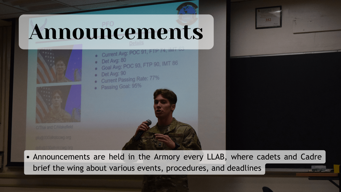 cadet with microphone in front of big screen with title: Announcements
