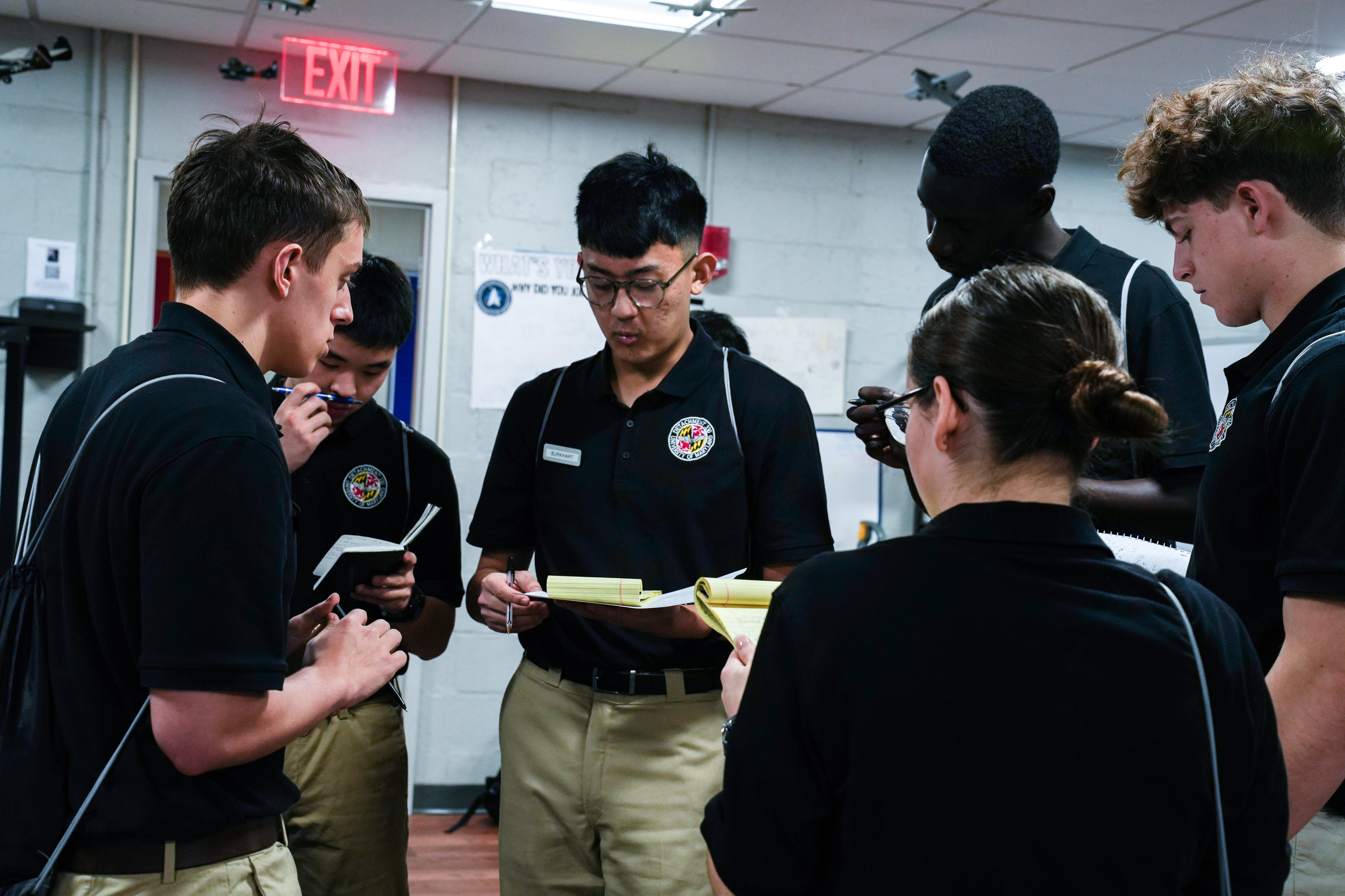 cadets with instructor holding clipboards